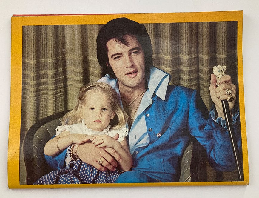 Vintage Platinum Magazine 1979 #6 presents Elvis Presley with a captivating photo featuring him holding a child, capturing a heartfelt moment that reflects the iconic singer's personality. This image is part of the collectible magazine's features, which celebrates Elvis Presley's legacy and includes a poster.