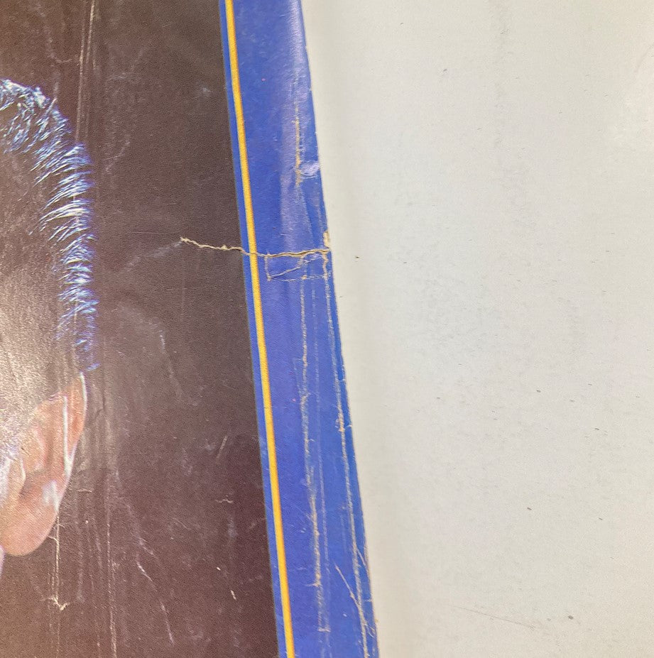 Close-up view of the back cover of the VTG Photoplay Magazine 1977 Elvis Presley A Tribute, highlighting the magazine's vintage wear and iconic Elvis imagery.