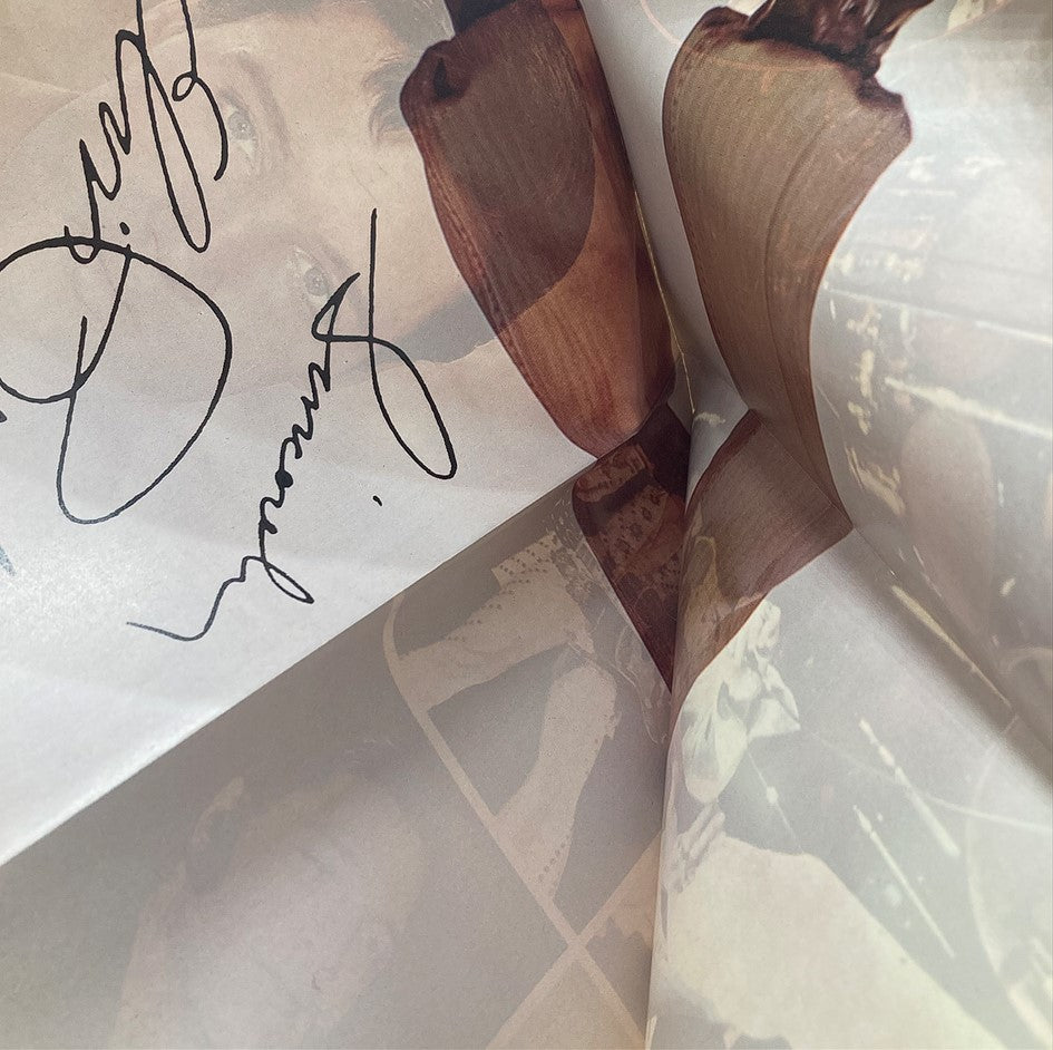 Close-up of the vintage 1977 Complete Elvis Presley Lists of Songs with Poster, featuring images and signatures from Elvis's career.