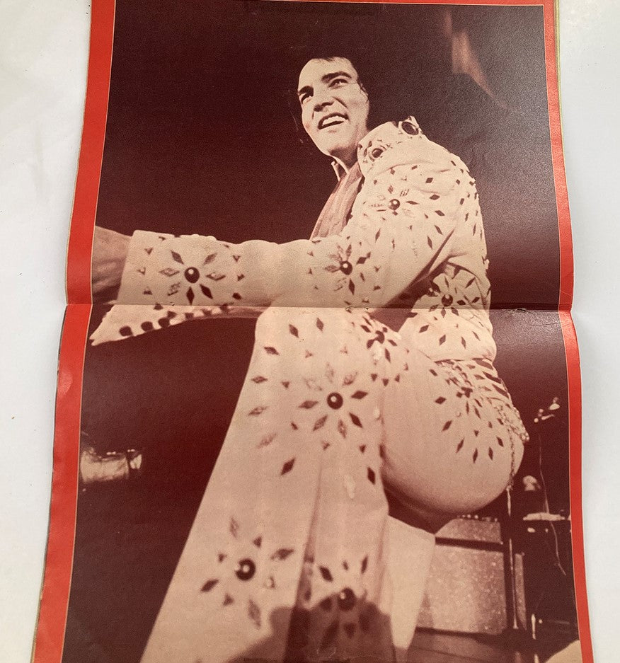 Folded poster image of Elvis Presley in a sparkling white jumpsuit, performing live. Featured in 'Yesterday Today Elvis Presley His Untold Life Story' vintage magazine from 1975.
