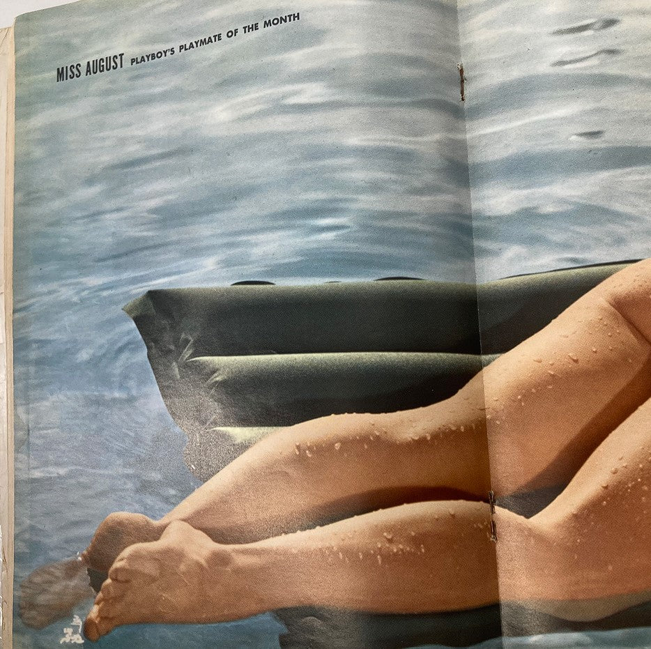 Centerfold page of Playboy Magazine August 1963, featuring a beautiful view of Miss August, Playmate of the Month, lounging on a float.