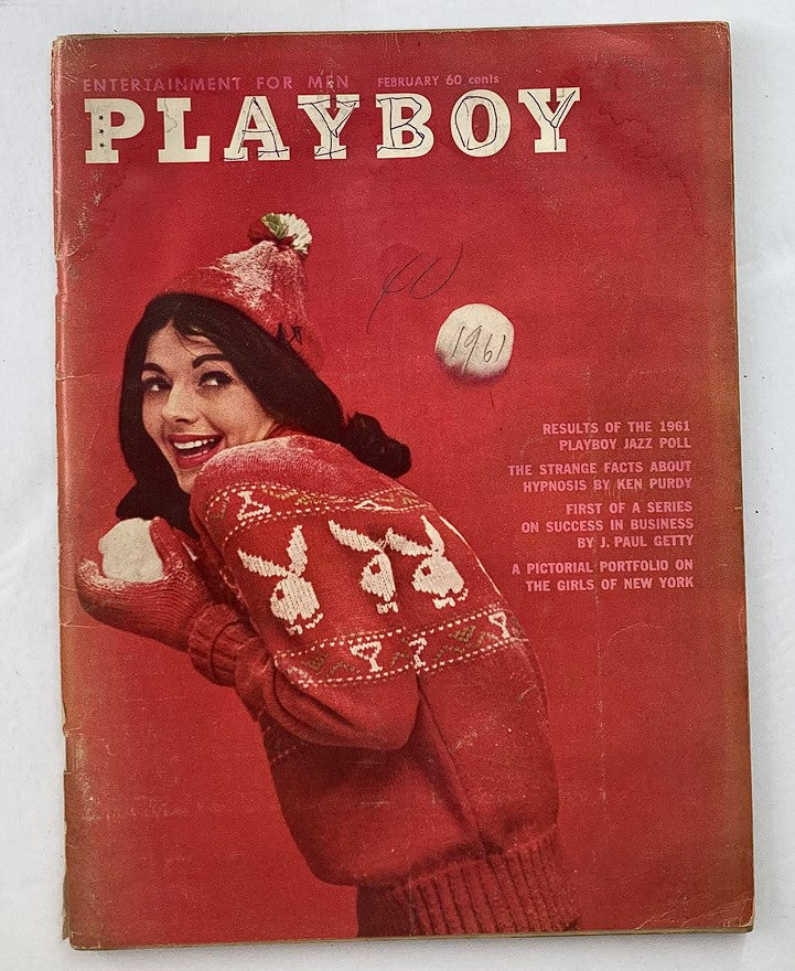 Playboy Magazine February 1961 cover featuring a smiling woman in a red sweater, capturing the vintage style of the era.