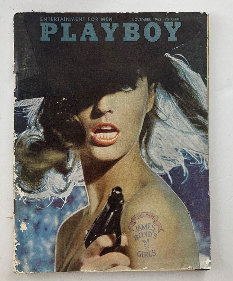 VTG Playboy Magazine November 1965 cover featuring Playmate Pat Russo, showcasing a glamorous model with a gun, representing 1960s pop culture.