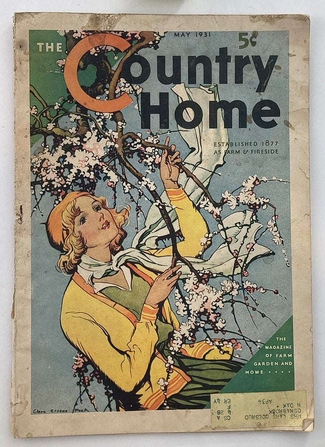 Cover of VTG The Country Home Magazine May 1931 features a vibrant illustration of a woman in a yellow cardigan holding blossoming branches, capturing the essence of early 20th-century rural living.