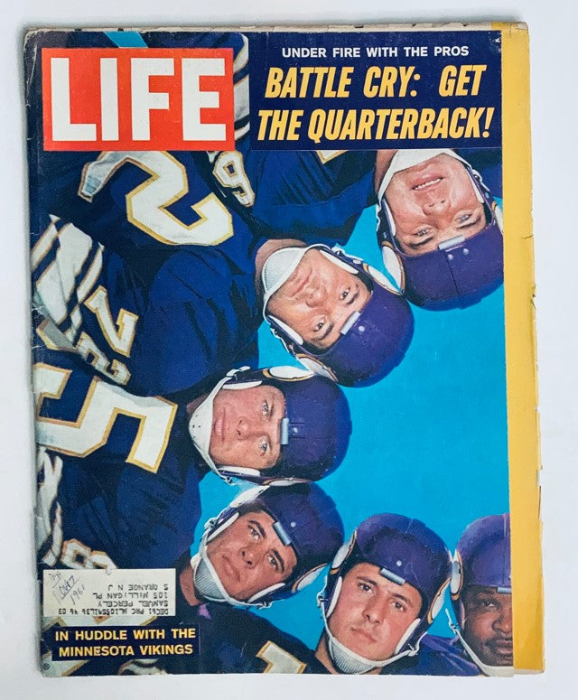Cover of VTG Life Magazine November 17, 1961, featuring Minnesota Vikings players in huddle, with bold text 'Battle Cry: Get the Quarterback!' showing vintage NFL history.