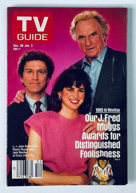 TV Guide Magazine cover from December 28, 1985 featuring Jack Warden, John Rubinstein, and Penny Peyser, highlighting the 1985 in review with 'Our J. Fred Muggs Awards for Distinguished Foolishness'