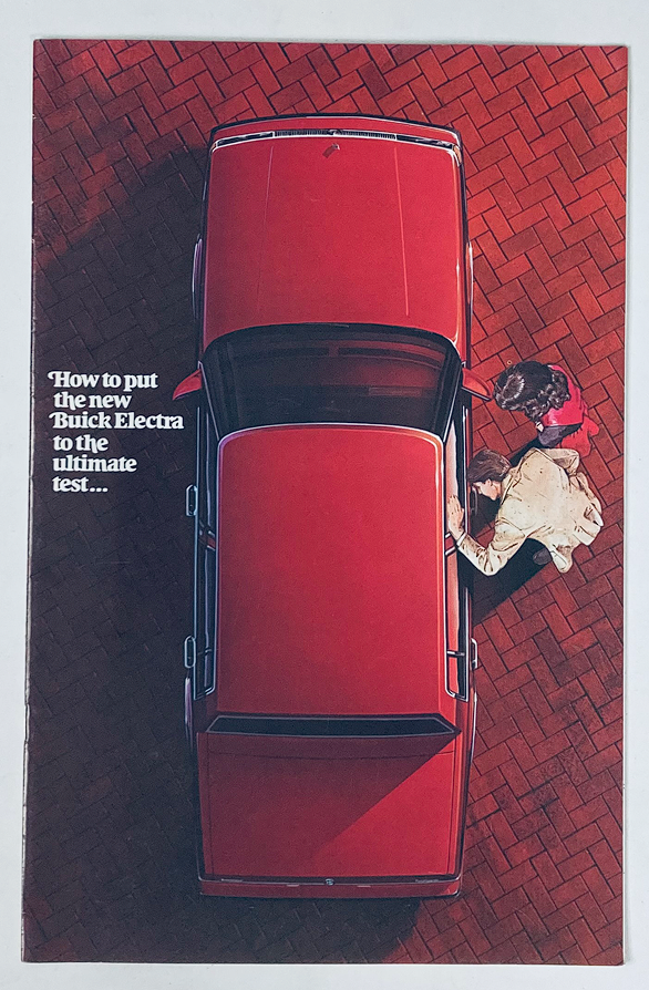 Aerial view of a 1985 Buick Electra parked on a brick driveway, showcasing the car's elegant design, featured in the 1985 Buick Electra Dealer Showroom Sales Brochure Guide Catalog.