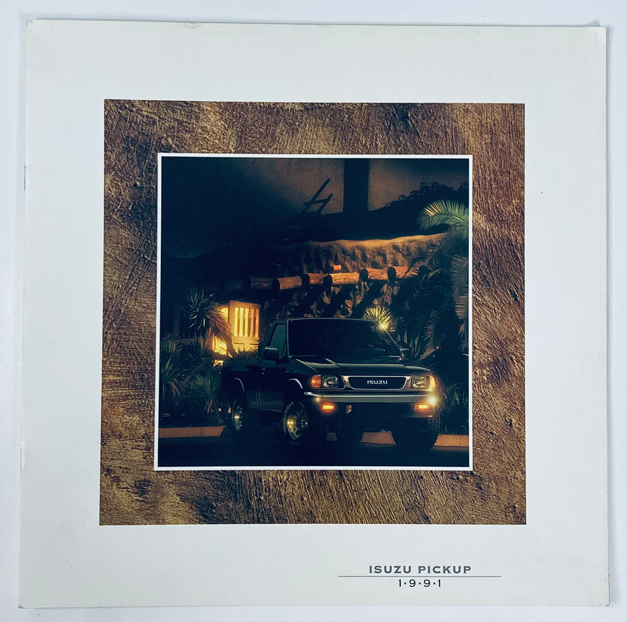 Cover of the 1991 Isuzu Pickup Dealer Showroom Sales Brochure Guide Catalog featuring an image of the Isuzu Pickup in a nighttime setting with foliage.