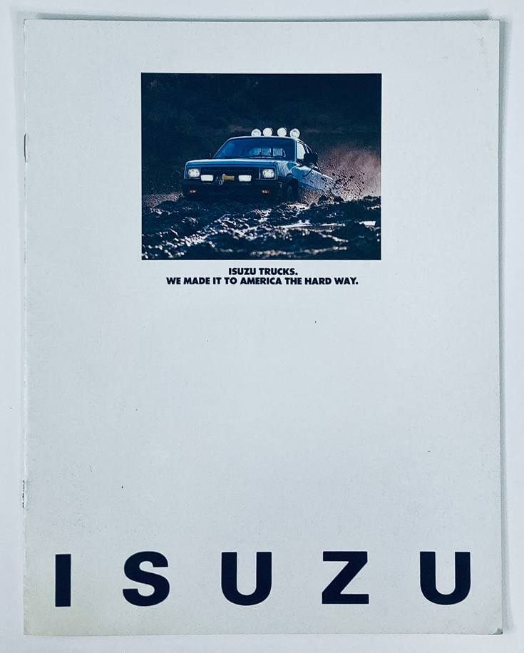 Cover of the 1981 Isuzu Trucks Dealer Showroom Sales Brochure Guide Catalog, featuring a rugged Isuzu truck navigating through difficult terrain with the tagline 'ISUZU TRUCKS. WE MADE IT TO AMERICA THE HARD WAY.'