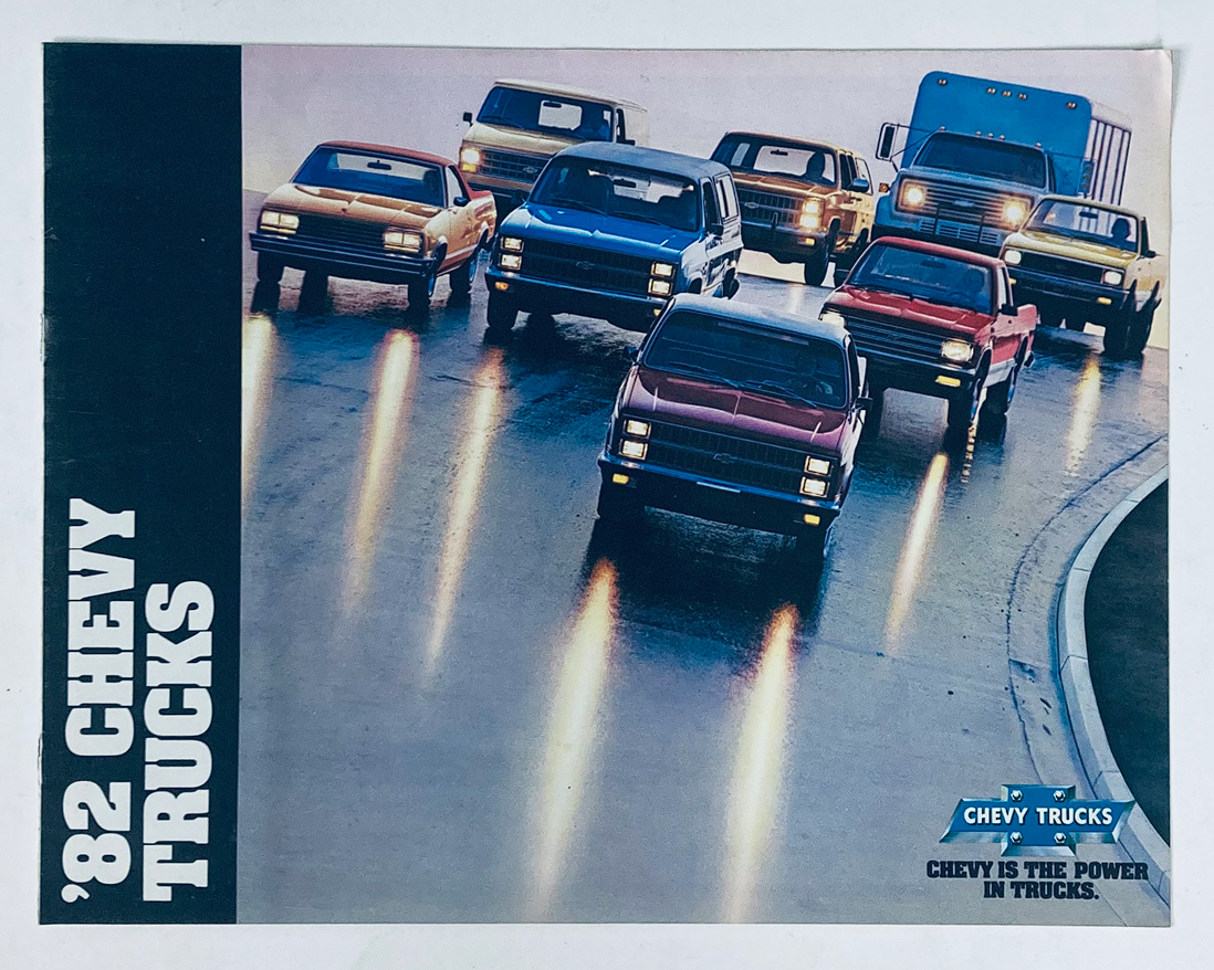 '82 Chevy Trucks promotional image showcasing a lineup of Chevrolet trucks against a scenic background. Part of the 1982 Chevrolet Trucks Dealer Showroom Sales Brochure Guide Catalog, highlighting the variety and capabilities of Chevy trucks.