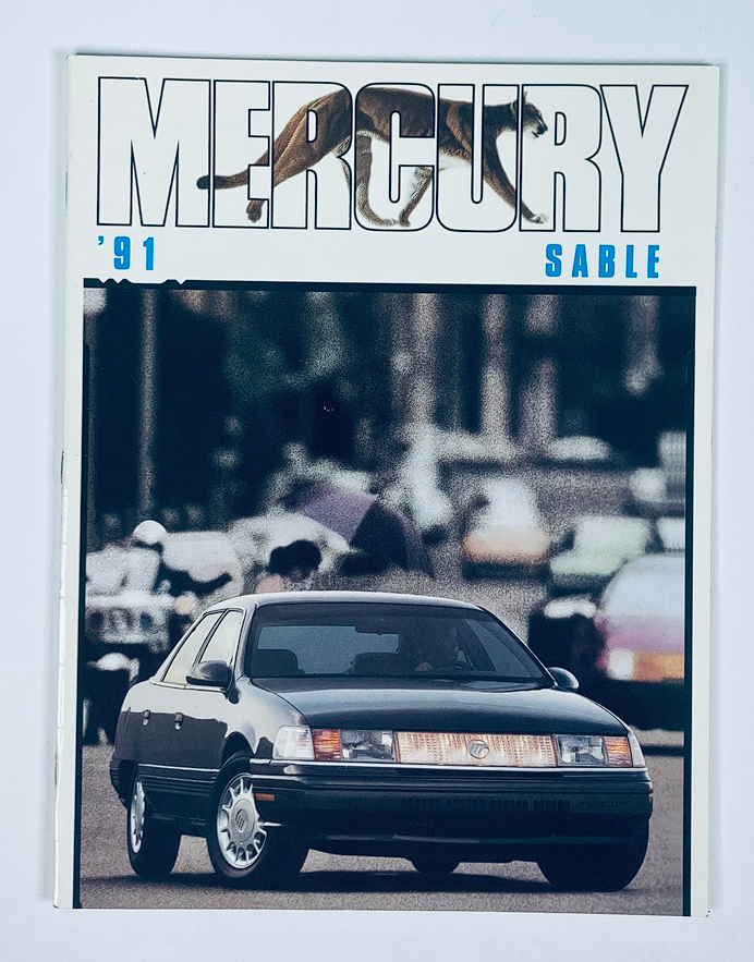 1991 Mercury Sable Dealer Showroom Sales Brochure featuring a black Mercury Sable car in front of a blurred background depicting a busy street.