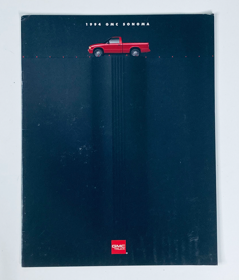 Cover of the 1994 GMC Sonoma Dealer Showroom Sales Brochure Guide Catalog featuring a red GMC Sonoma truck on a black background.