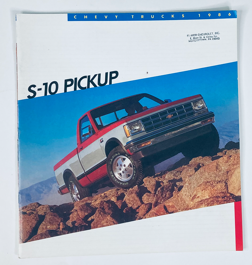 1986 Chevrolet Trucks S-10 Pickup Dealer Showroom Sales Brochure Guide Catalog featuring a red and white S-10 pickup truck on rocky terrain, showcasing the vehicle's design and rugged capability.