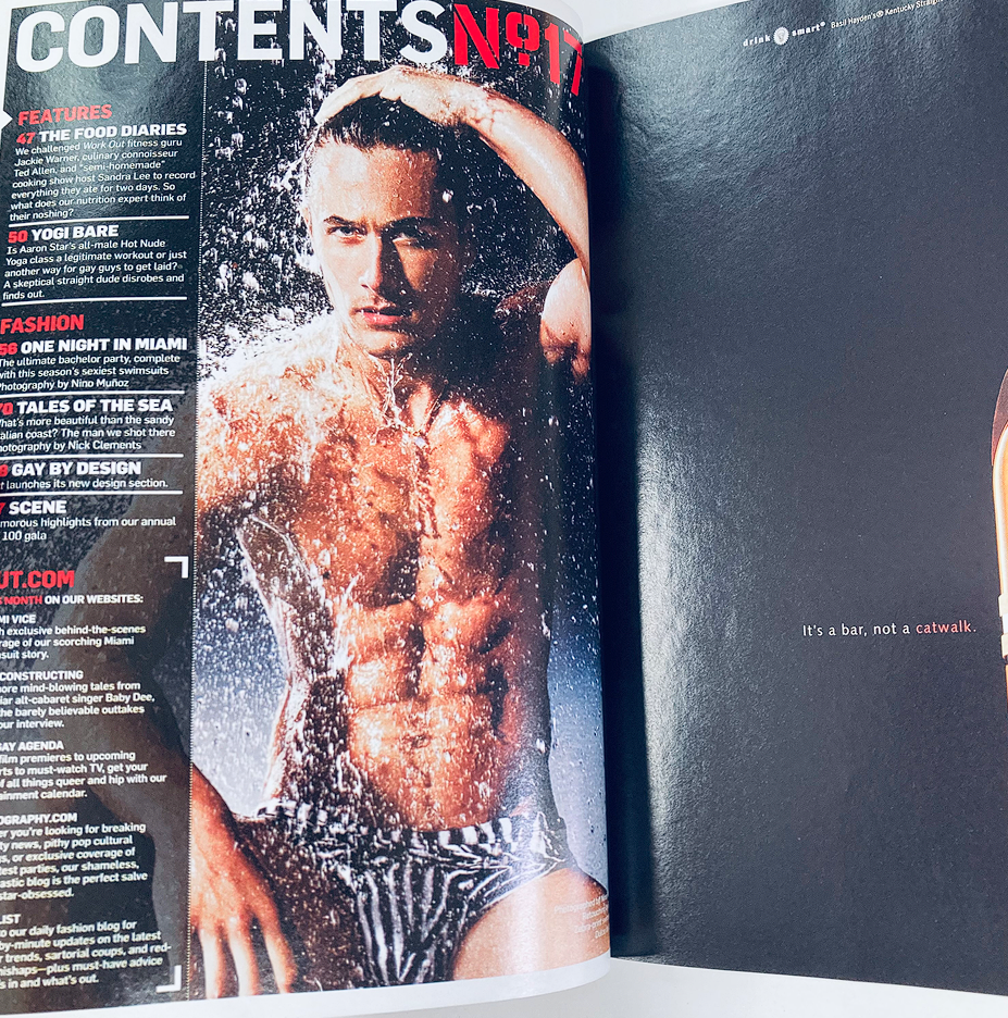 Interior page of Out Magazine February 2008 with content list, highlighting features such as swimwear fashion and fitness insights, alongside an image of a model with a stylish physique.