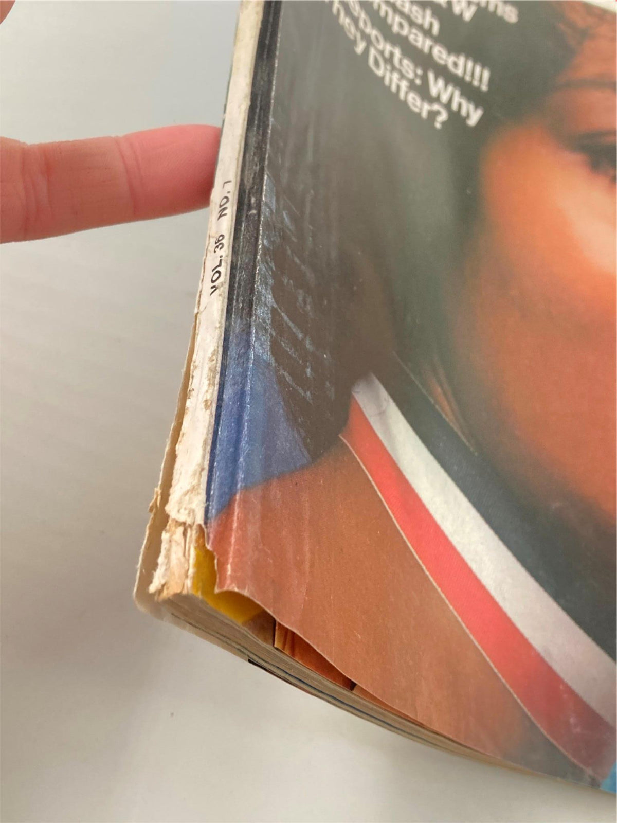 Side view of VTG Modern Photography Magazine July 1972, showing wear and tear, including a torn edge, while displaying the title and coverage of skin tone exposure issues.