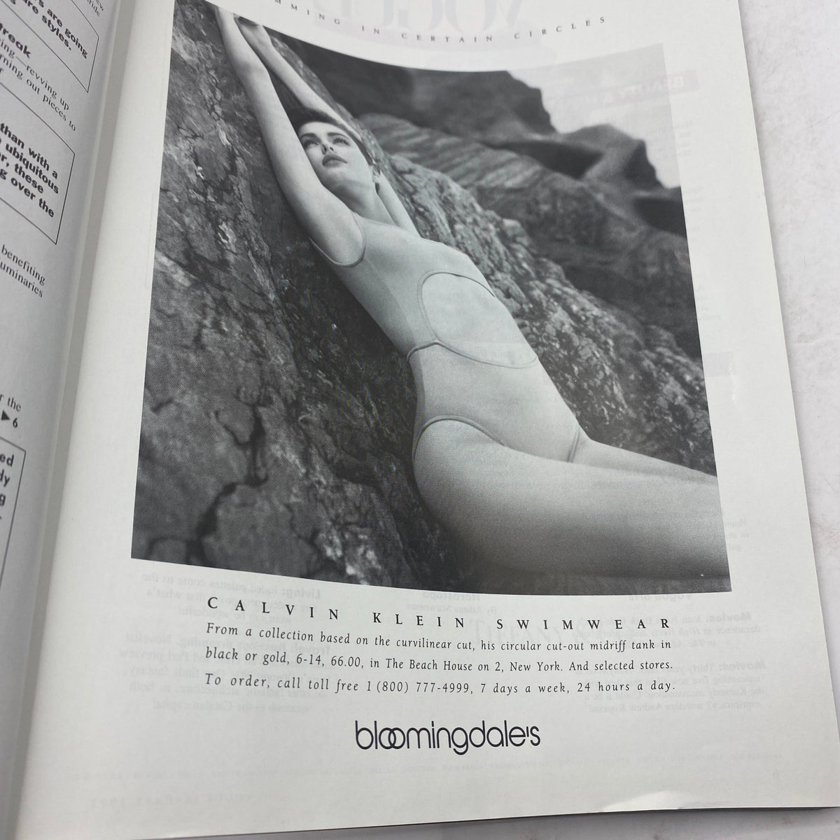Black and white advertisement for Calvin Klein swimwear in Vogue Magazine January 1992, displaying a model in a stylish cut-out swimsuit, emphasizing fashion innovation of the era.