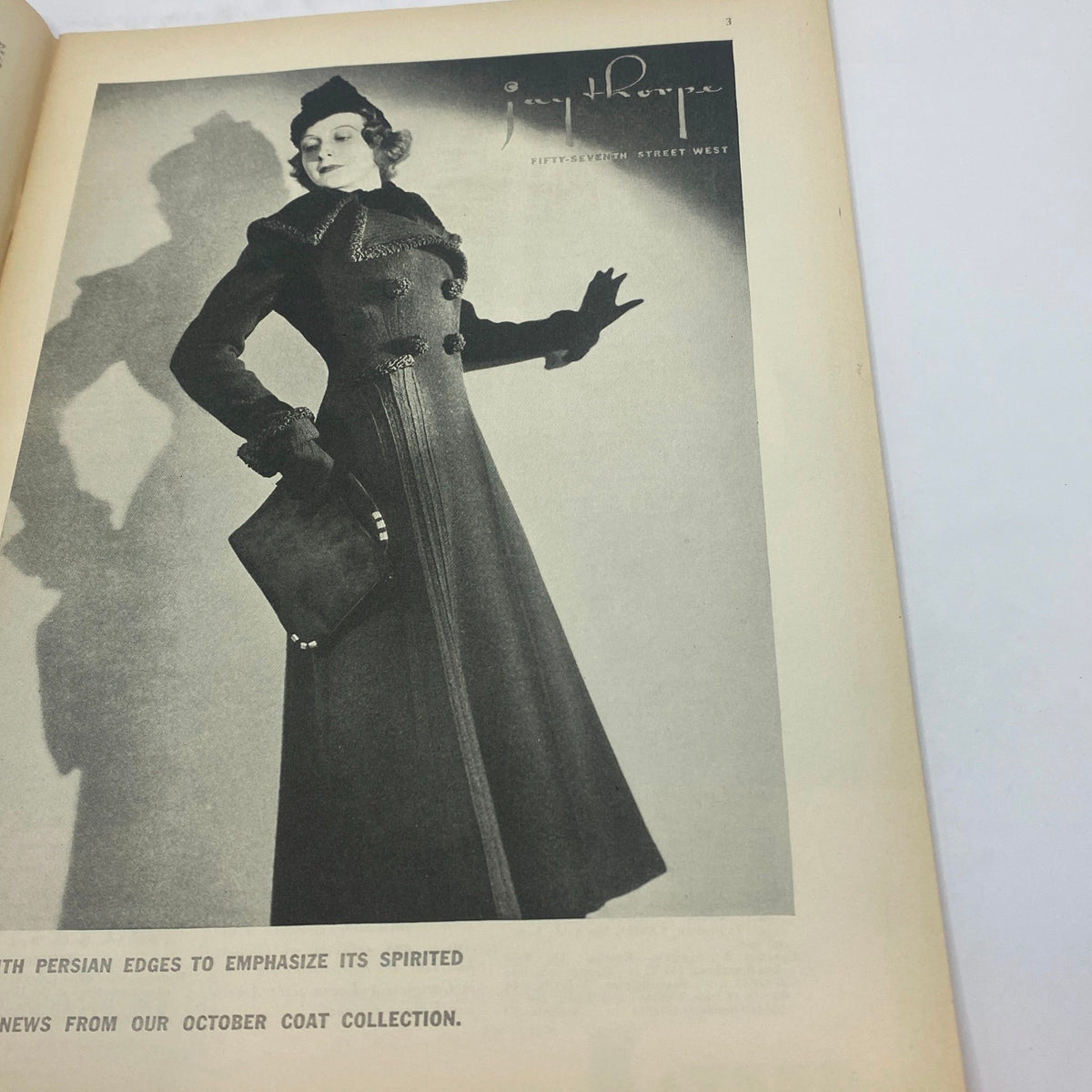 Fashion advertisement showcasing a model in a stylish coat from The New Yorker Complete Magazine October 3, 1936.