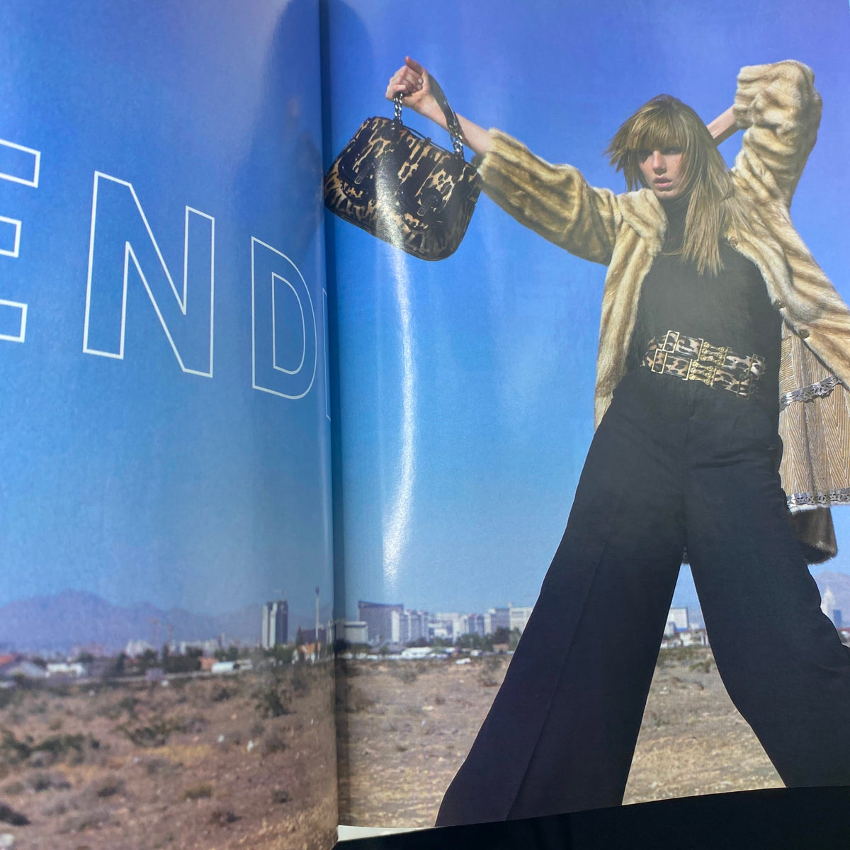 Fashion spread from Elle Magazine October 2006 displaying models in stylish outfits against a desert backdrop.