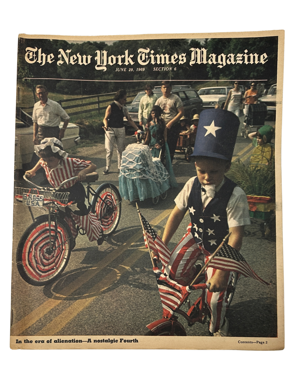 The New York Times Magazine June 29, 1969 Fourth of July Parade America Cover featuring children in patriotic costumes, including a young boy in a star-spangled top hat riding a decorated bicycle, symbolizing American Independence Day celebrations.