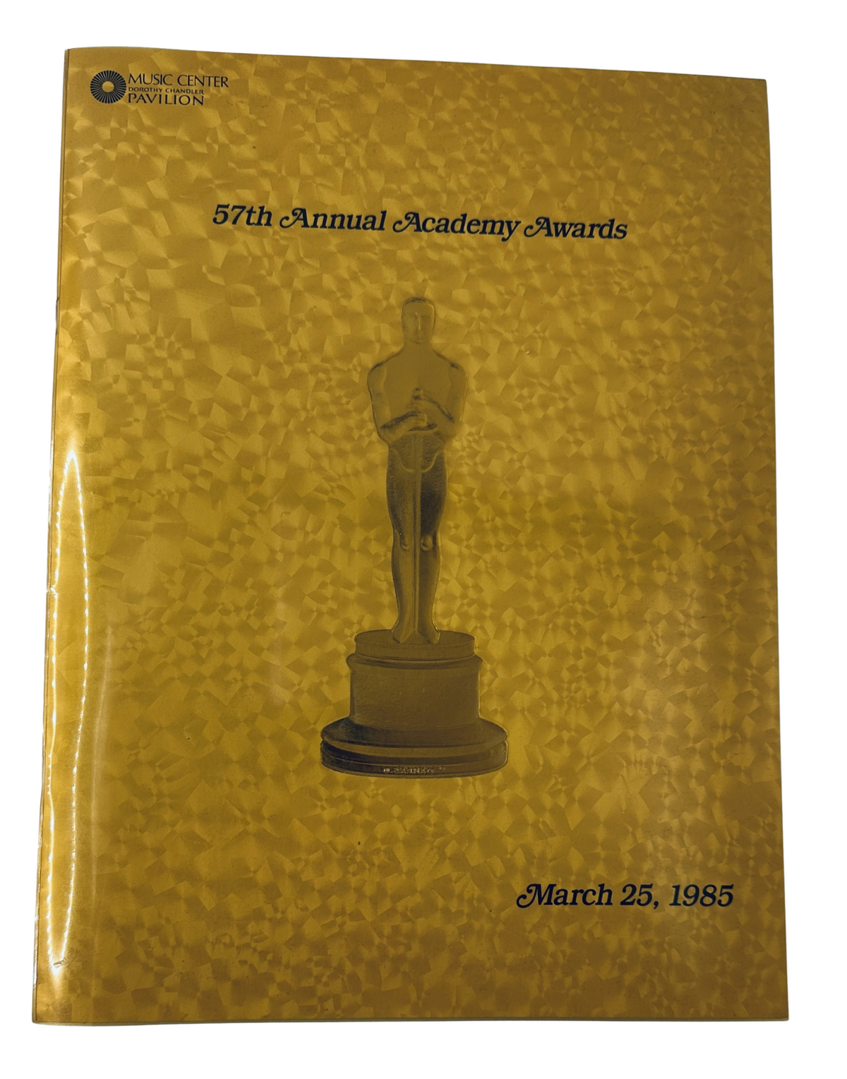 Oscar Magazine 57th Annual Academy Awards Program, featuring a golden cover with an Oscar statuette, dated March 25, 1985.