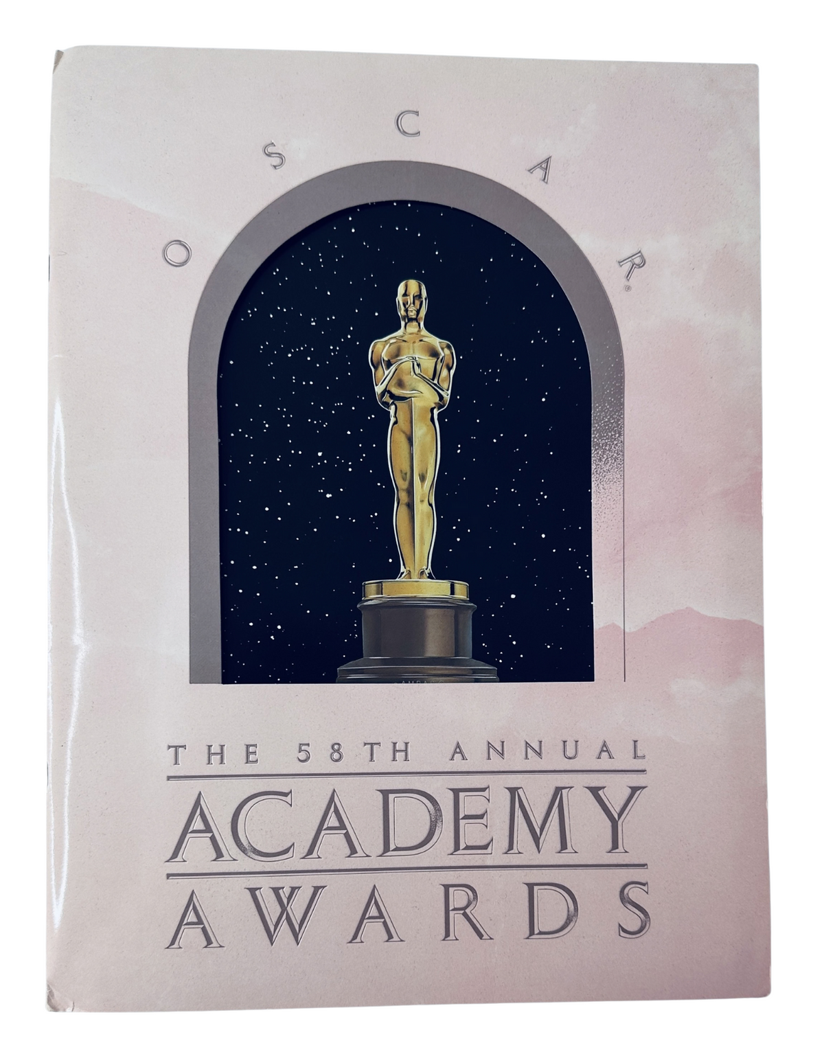 Cover of the Oscar Magazine 58th Annual Academy Awards 1986 Program, featuring a golden Oscar statue against a starry background.
