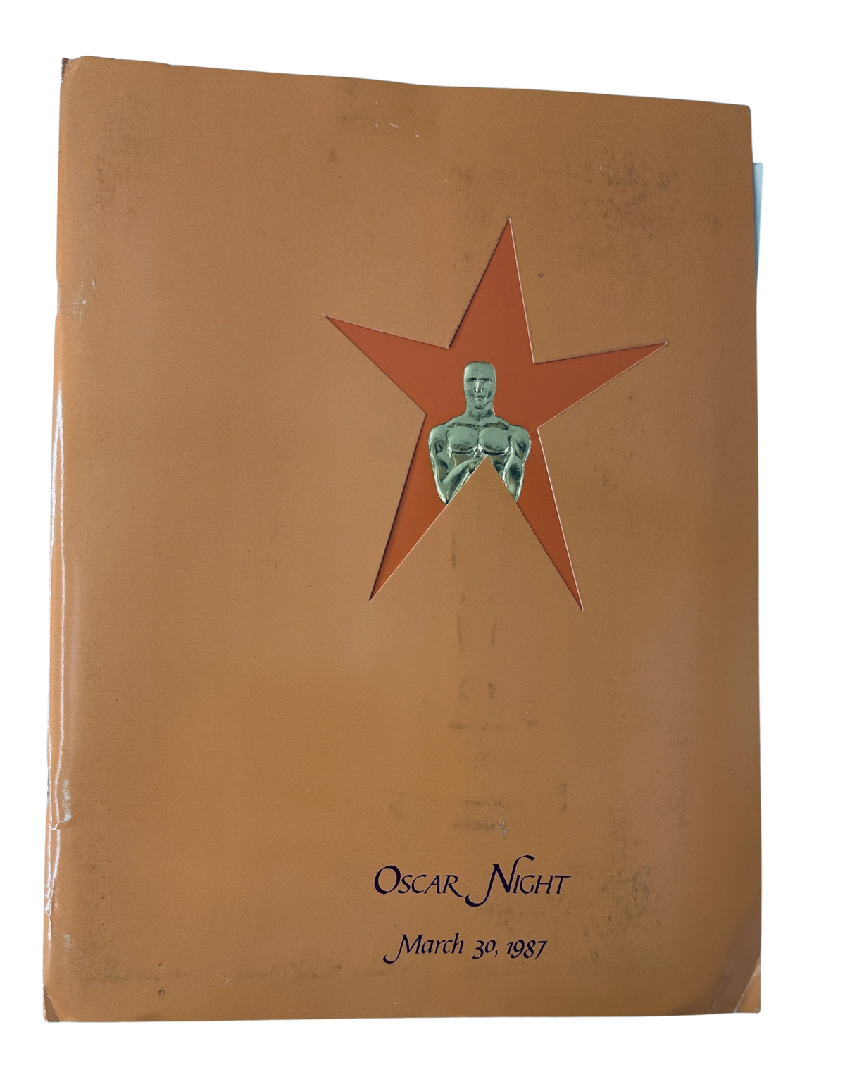 Cover of the Oscars Night Magazine dated March 30, 1987, featuring a star design and an embossed Oscar statuette.