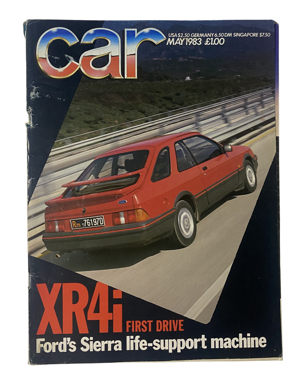 Cover of Car Magazine May 1983 featuring the Ford Sierra XR4i, described as Ford's Sierra life-support machine. The magazine highlights the first drive of the XR4i with a striking image of the red car on a scenic highway.
