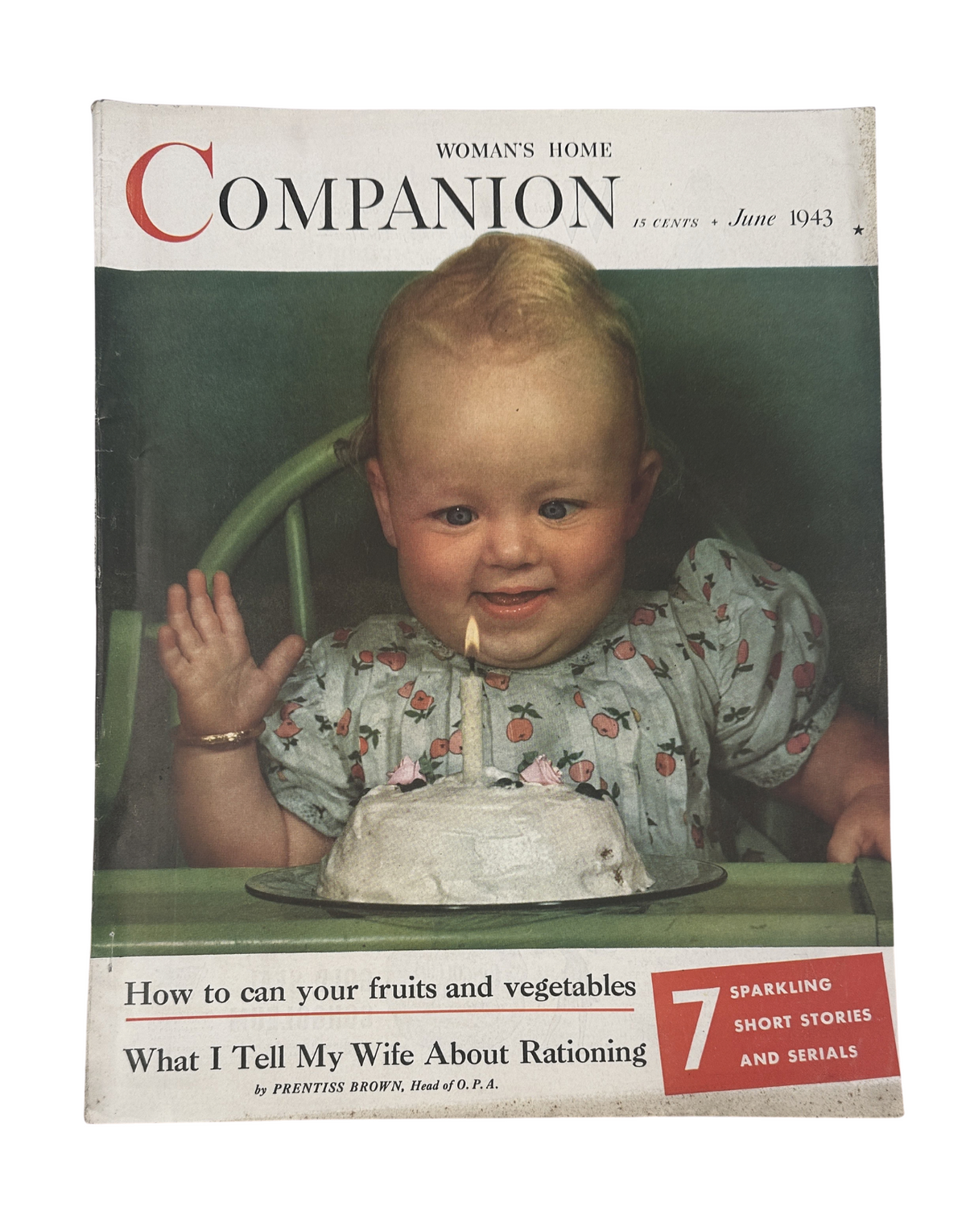 Cover of Woman’s Home Companion Magazine from June 1943, featuring a cheerful baby holding a cake, alongside the article headline 'What I Tell My Wife About Rationing'.
