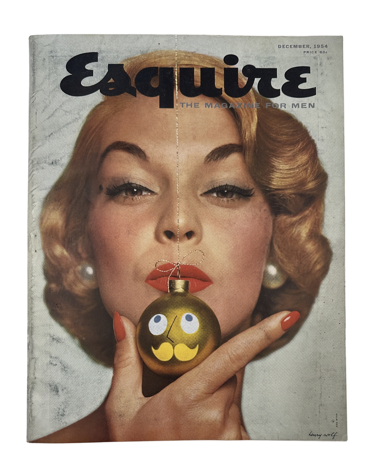 December 1954 Esquire Magazine cover featuring a glamorous woman holding a Christmas ornament, highlighting vintage aesthetics and holiday themes.