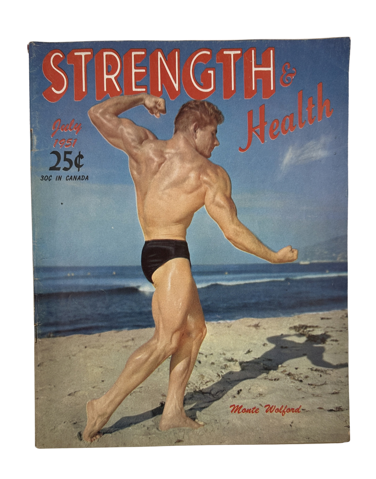 Cover of Strength and Health Magazine, July 1951 featuring Monte Wolford showcasing bodybuilding muscles against a beach backdrop.