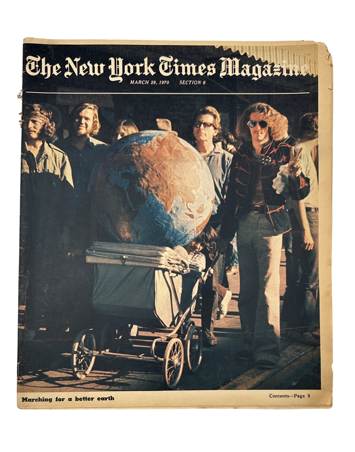 Cover of The New York Times Magazine dated March 29, 1970, featuring a protest for Earth Day with a group of individuals and a large globe. It highlights the theme of ecology and environmental advocacy.