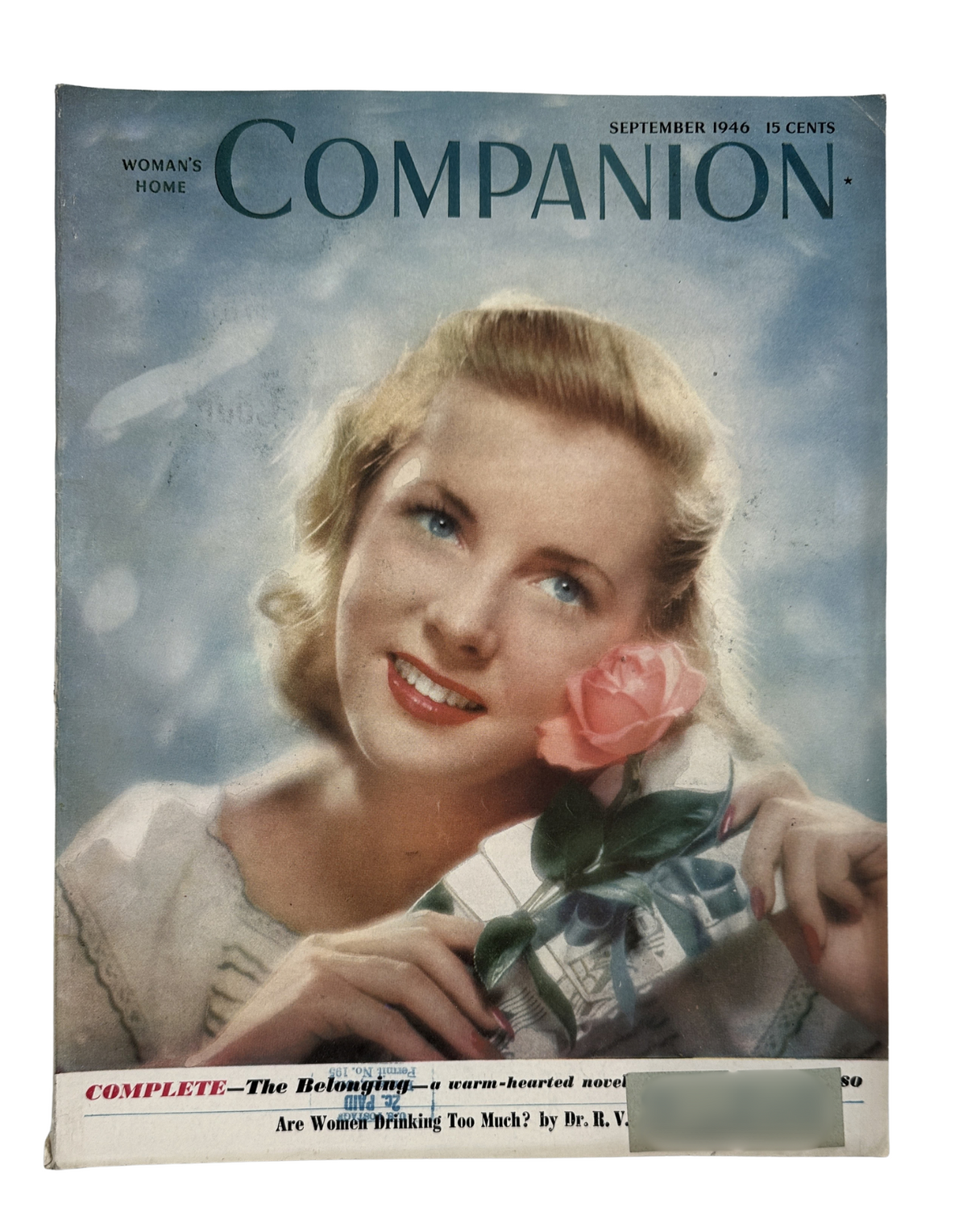 Cover of Woman’s Home Companion Magazine from September 1946 featuring a smiling woman holding a rose. This vintage magazine showcases MCM fashion and style.