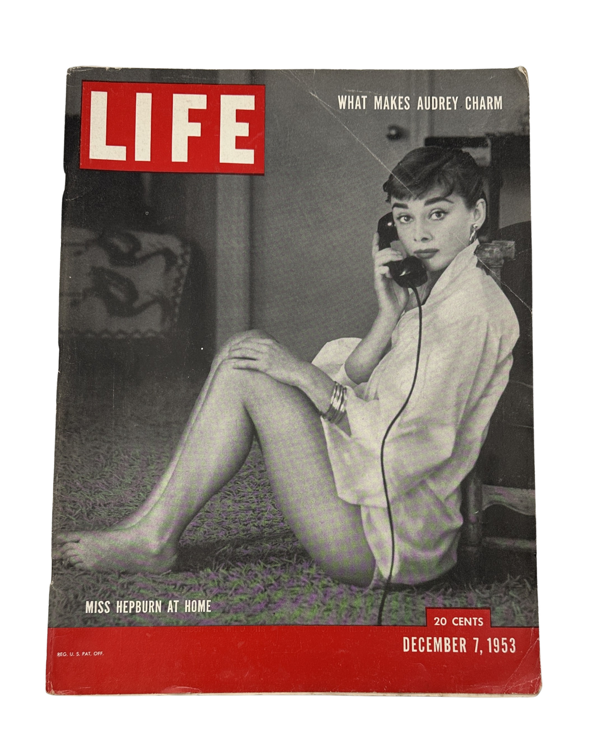 Life Magazine December 7, 1953 cover featuring Audrey Hepburn at home, showcasing her charm while holding a telephone.