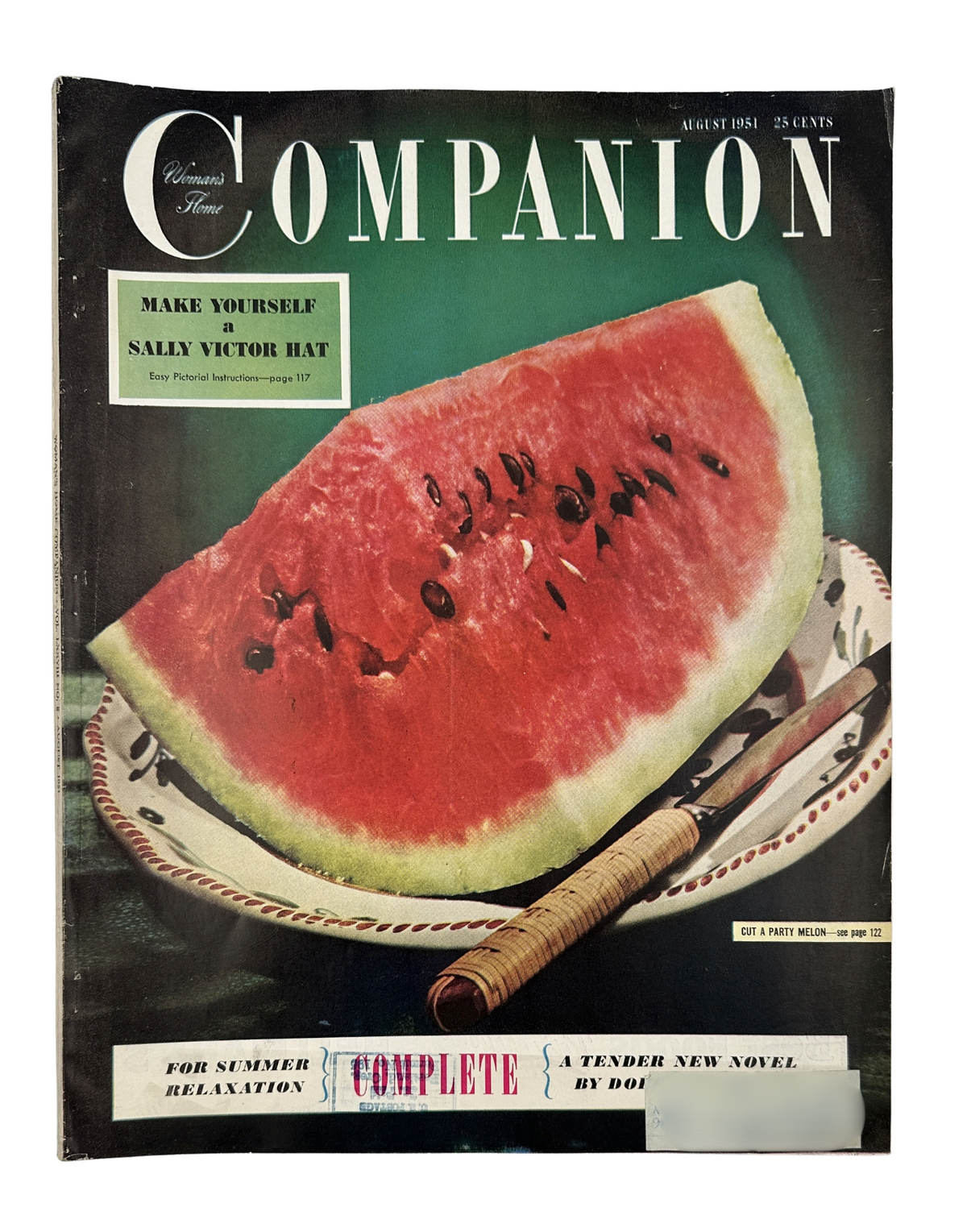 Cover of Woman’s Home Companion Magazine August 1951 featuring a vibrant watermelon and a woven plate, highlighting the complete novel and DIY Sally Victor Hat project.