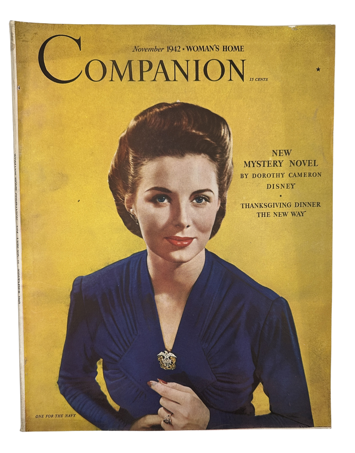 Cover of Woman’s Home Companion Magazine November 1942 featuring a portrait of a woman in a blue dress, promoting a new mystery novel by Dorothy Cameron Disney and Thanksgiving dinner ideas.
