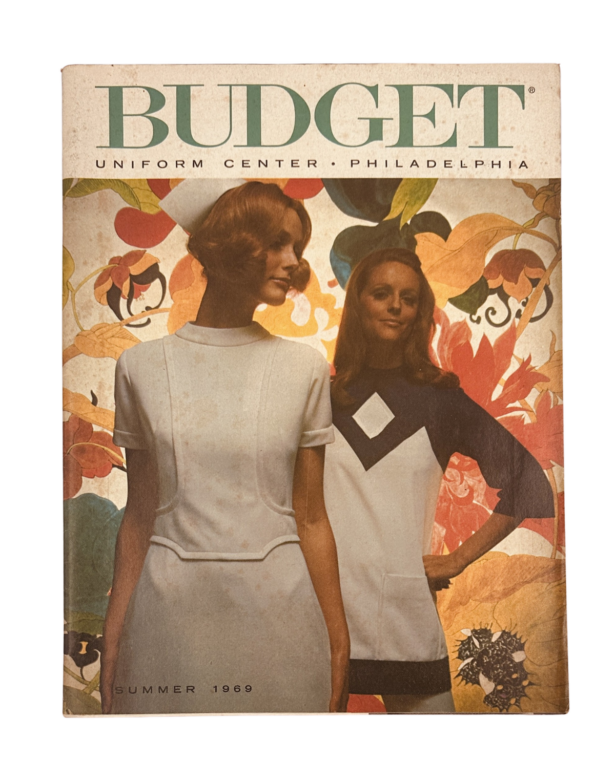 Cover of the 'Budget Uniform Center Catalog Summer 1969' showcasing two models in nurse uniforms amidst vibrant floral graphics, emphasizing medical fashion from the late 1960s.