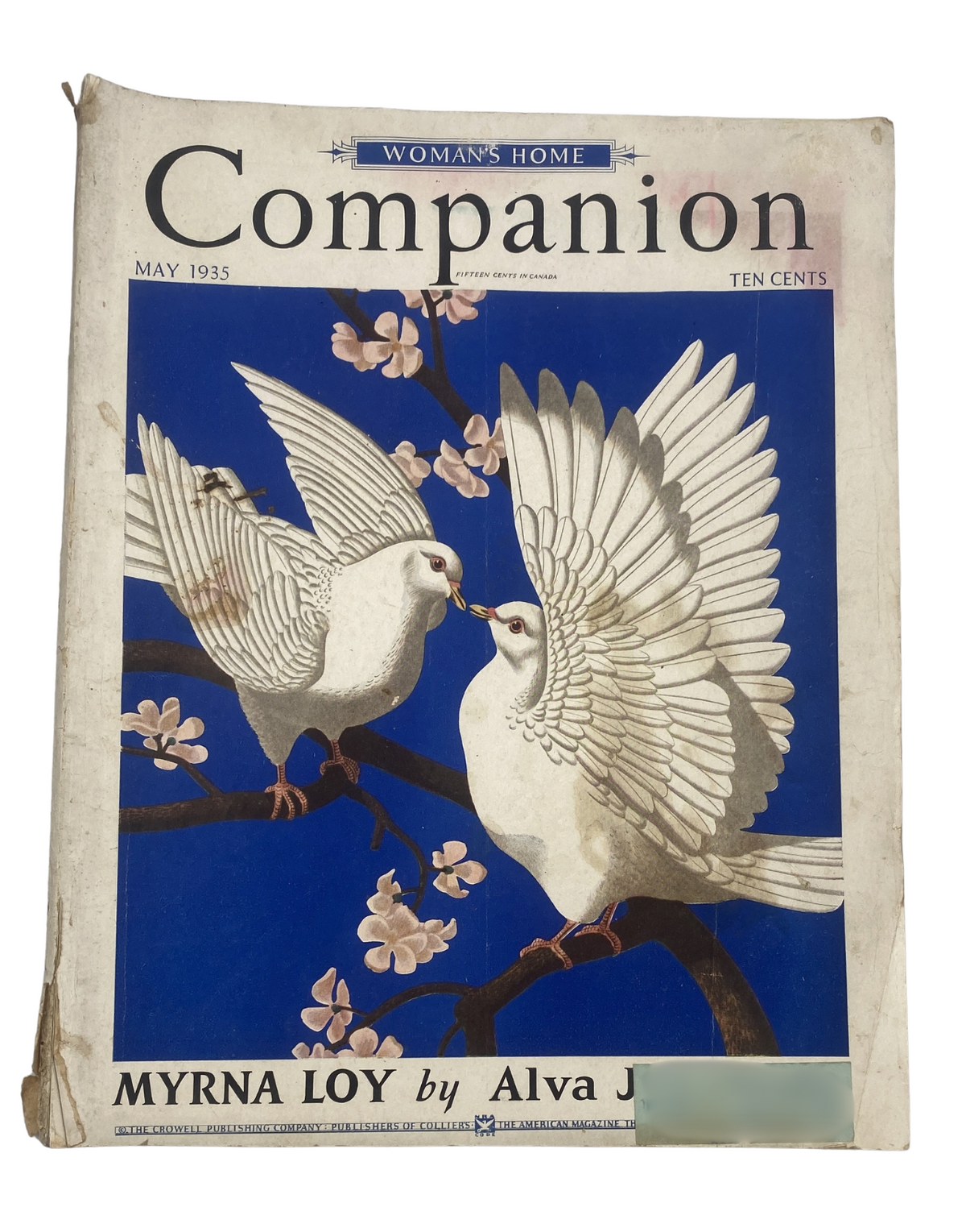 Cover of Woman’s Home Companion Magazine May 1935 featuring two white doves on a blue background, with Myrna Loy highlighted. The magazine showcases vintage art and design typical of the era.