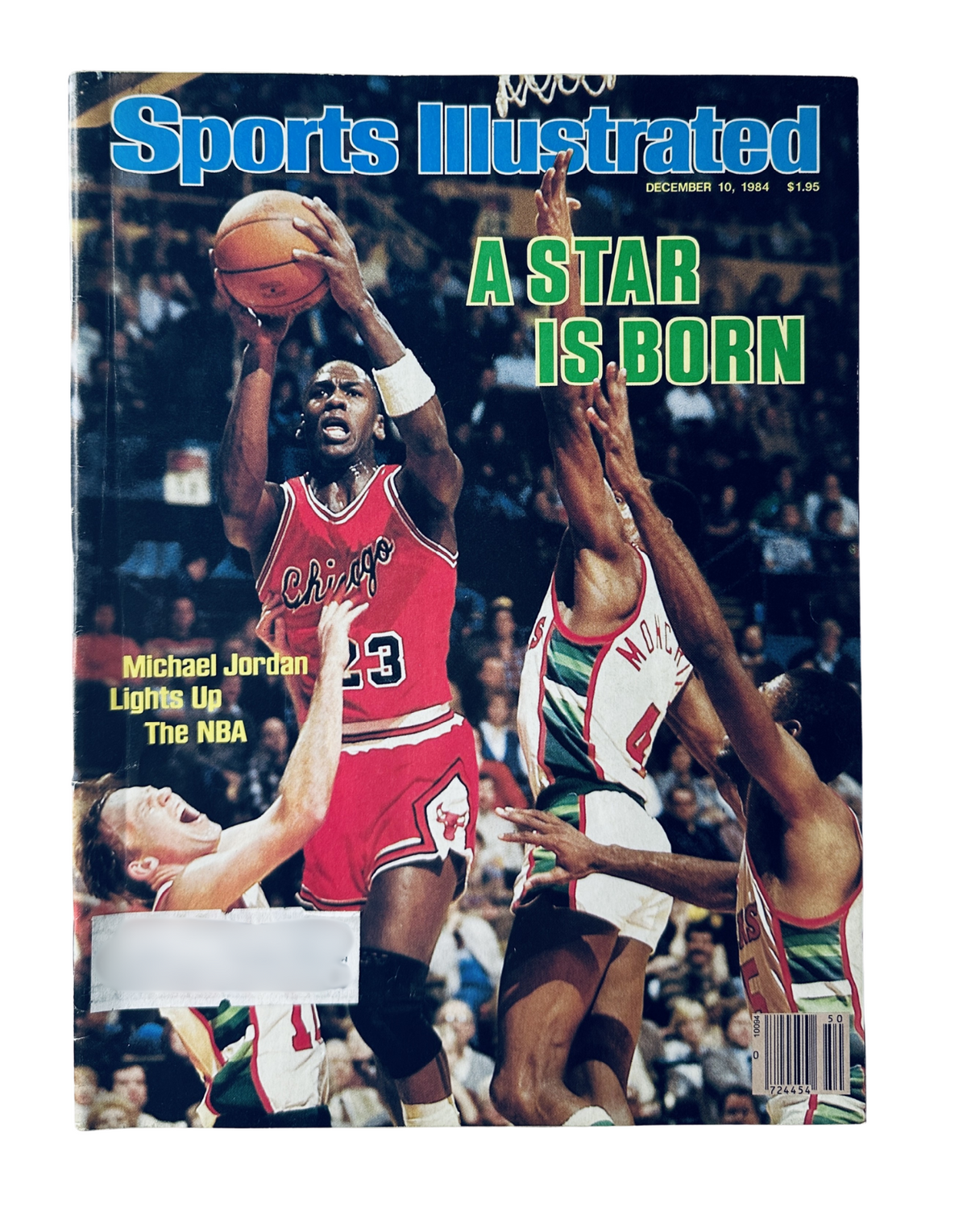 Sports Illustrated Magazine cover from December 10, 1984 showing Michael Jordan in action with the headline 'A Star Is Born'. The image captures Jordan shooting a basketball surrounded by defenders, highlighting his rookie status.