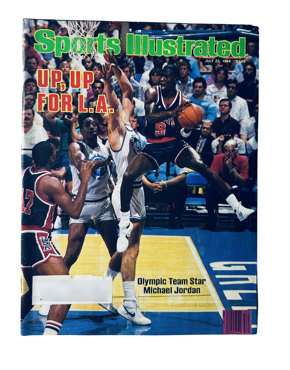 Sports Illustrated Magazine July 23, 1984 featuring Michael Jordan on the cover, showcasing his dynamic basketball skills during the Olympic games.
