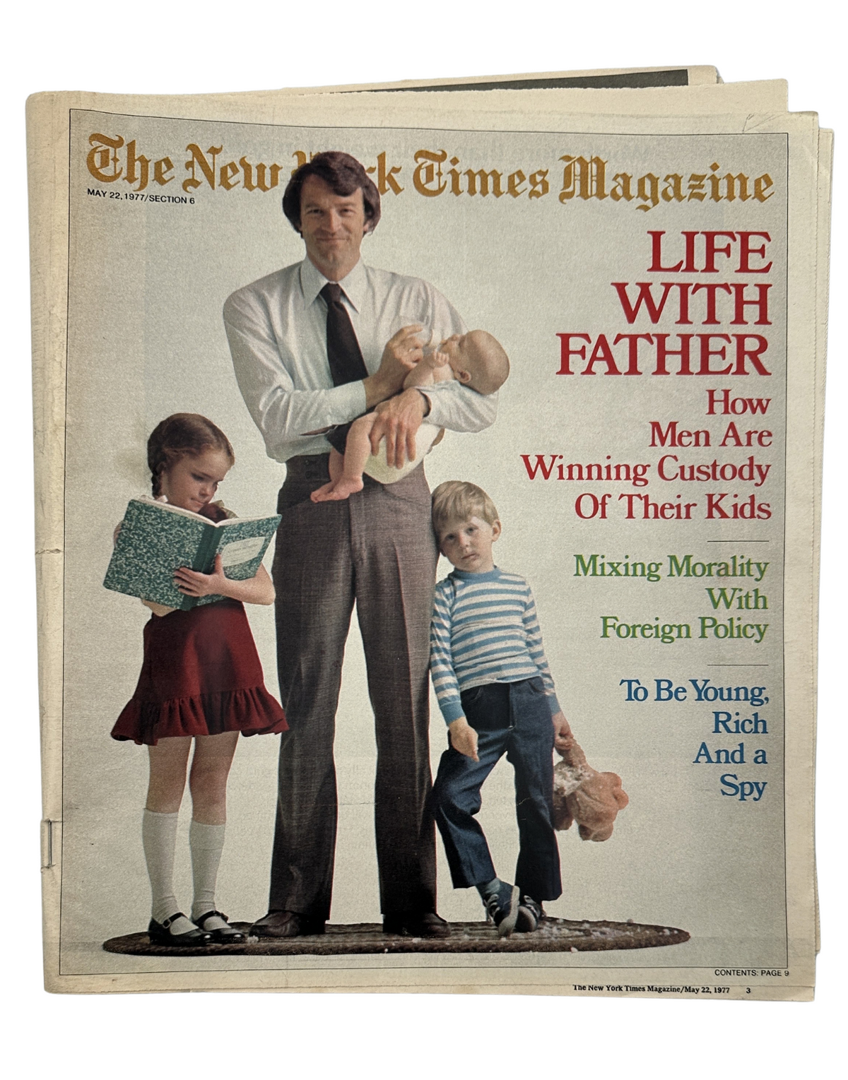 The New York Times Magazine May 22, 1977 cover featuring the title 'Life With Father,' exploring how men are winning custody of their kids, with a photograph of a father holding a baby, a young girl reading, and a boy standing beside them.