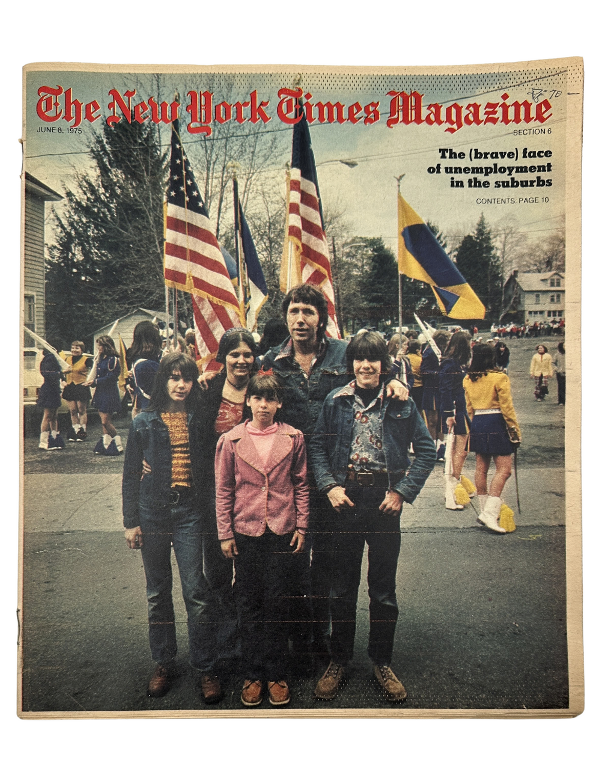 The New York Times Magazine June 8, 1975 cover featuring a family standing in front of a parade with flags and cheerleaders, illustrating the theme of unemployment in the suburbs.
