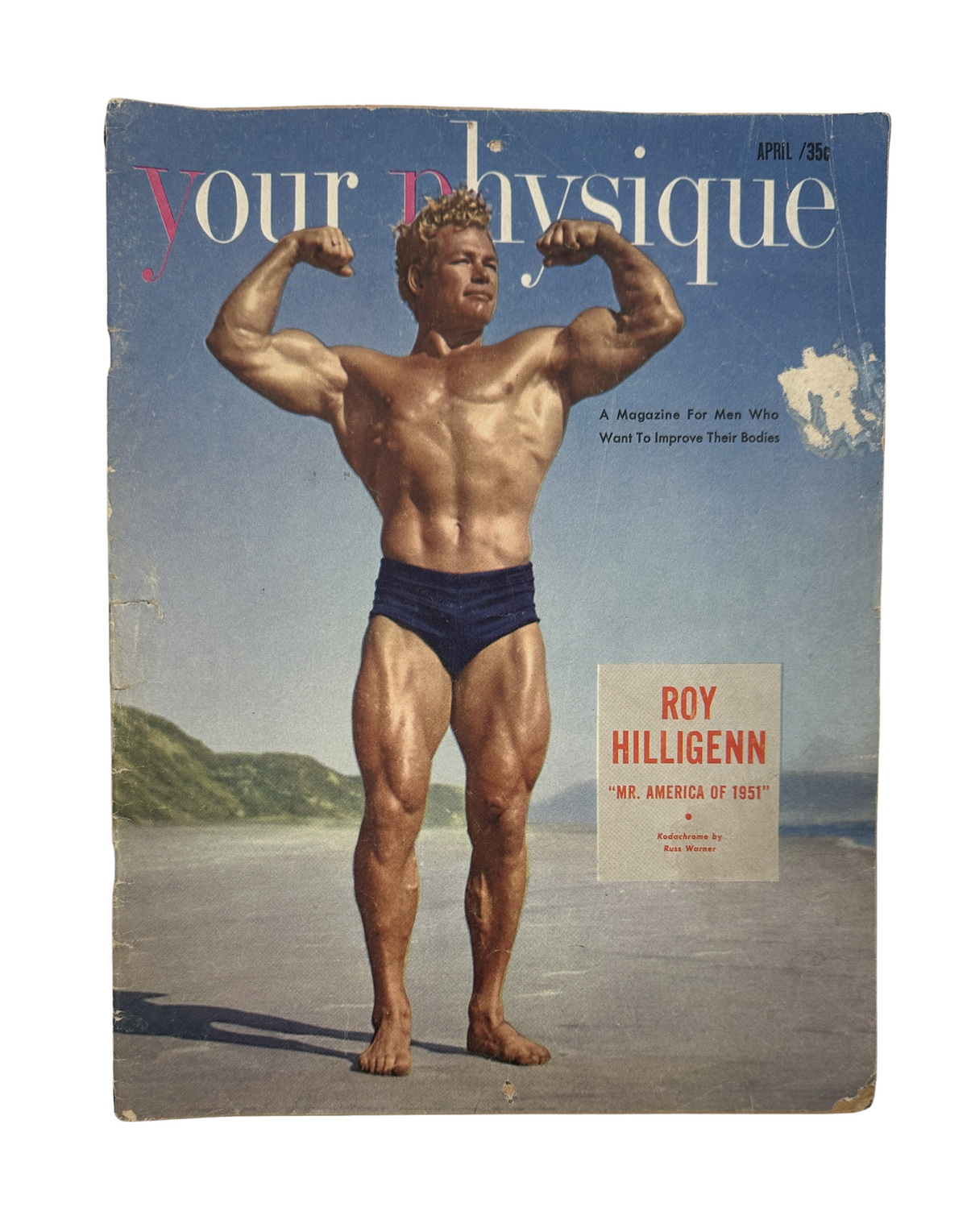 Your Physique Magazine April 1952 cover featuring Roy Hilligenn, Mr. America, showcasing a muscular physique on a beach background.