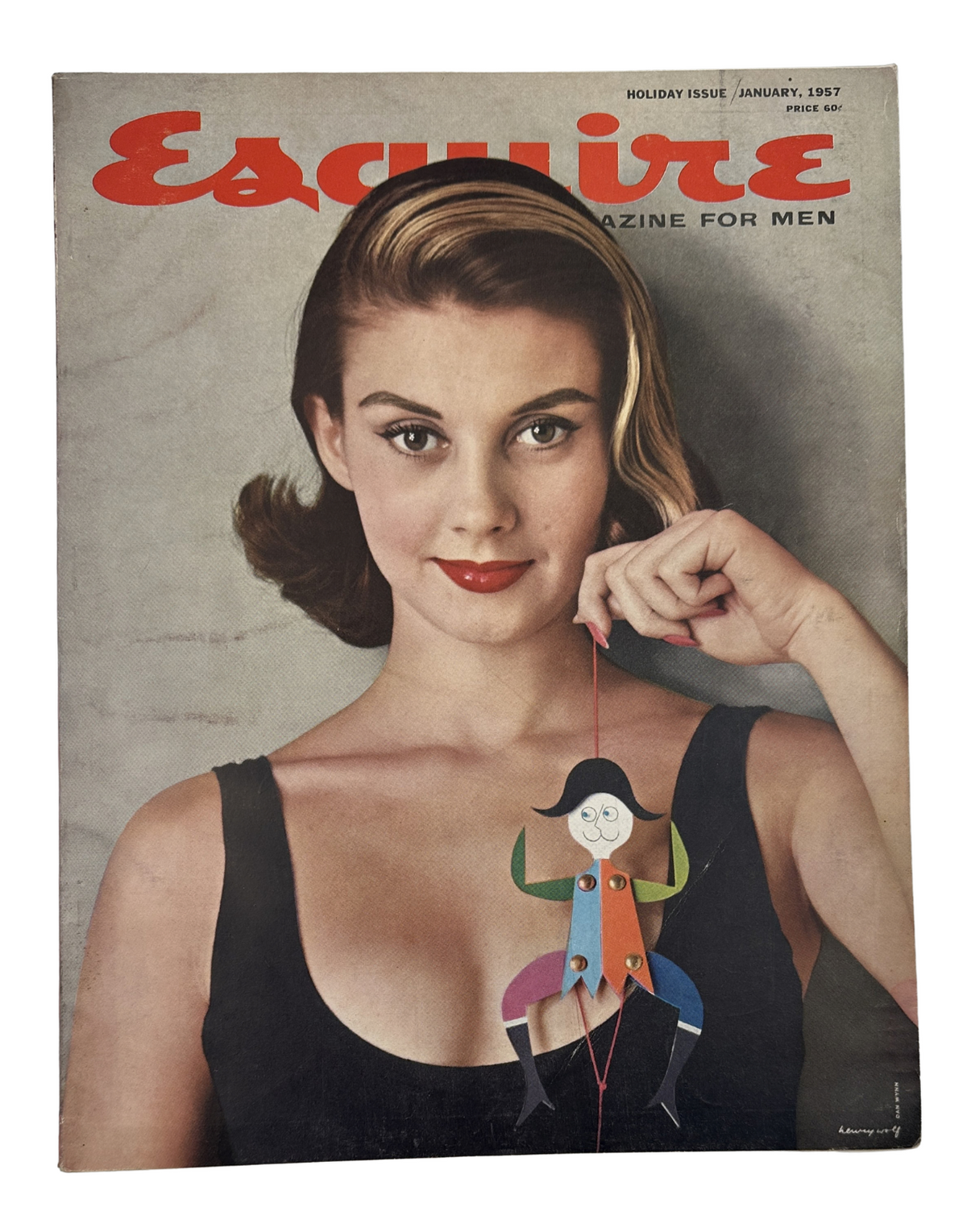 Cover of Esquire Magazine January 1957 featuring a woman holding a playful puppet, showcasing a jazz theme with vintage style.