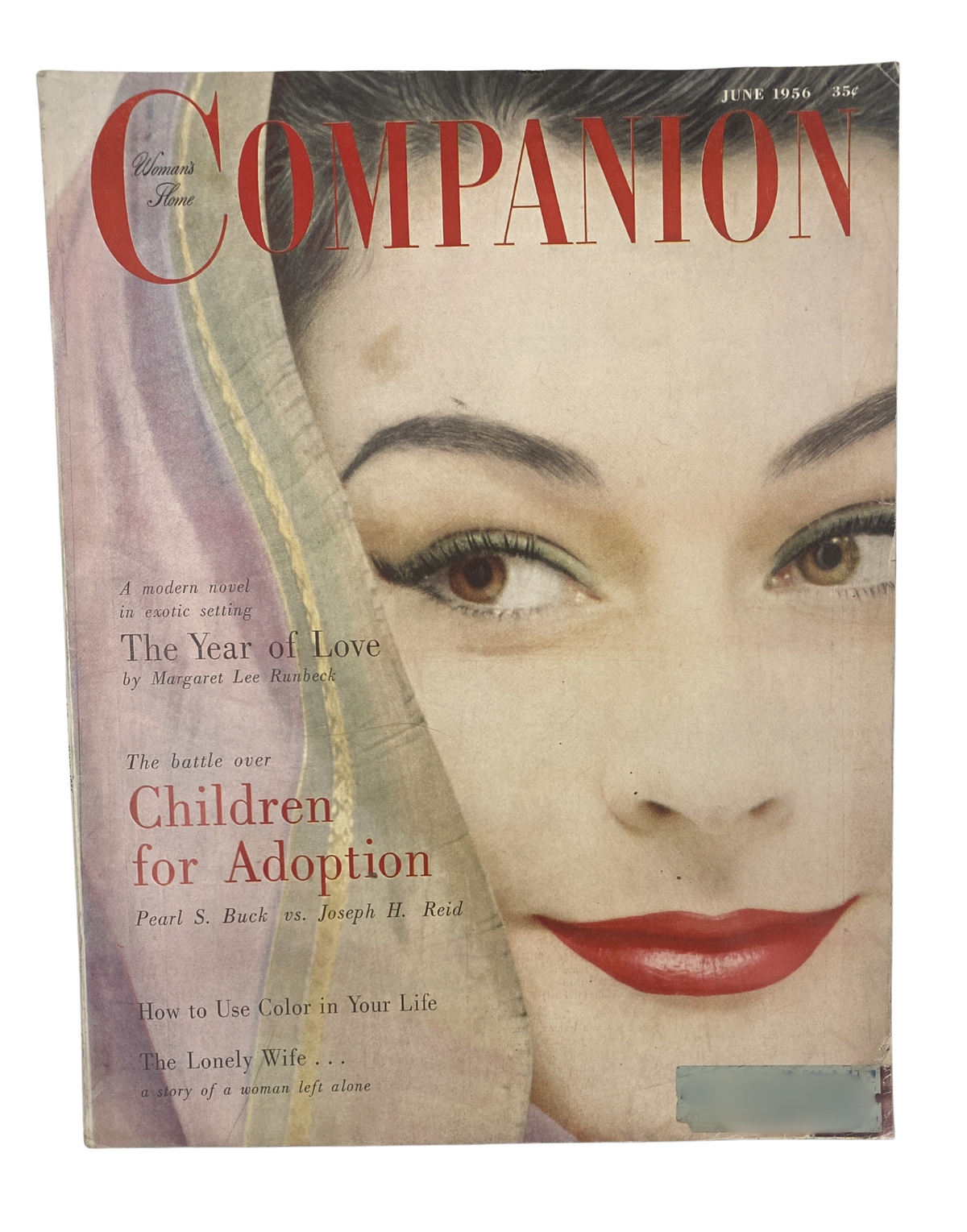 Cover of Woman’s Home Companion Magazine from June 1956 featuring 'The Year of Love' by Margaret Lee Runbeck, with an elegant model showcasing beautiful makeup and a headscarf.