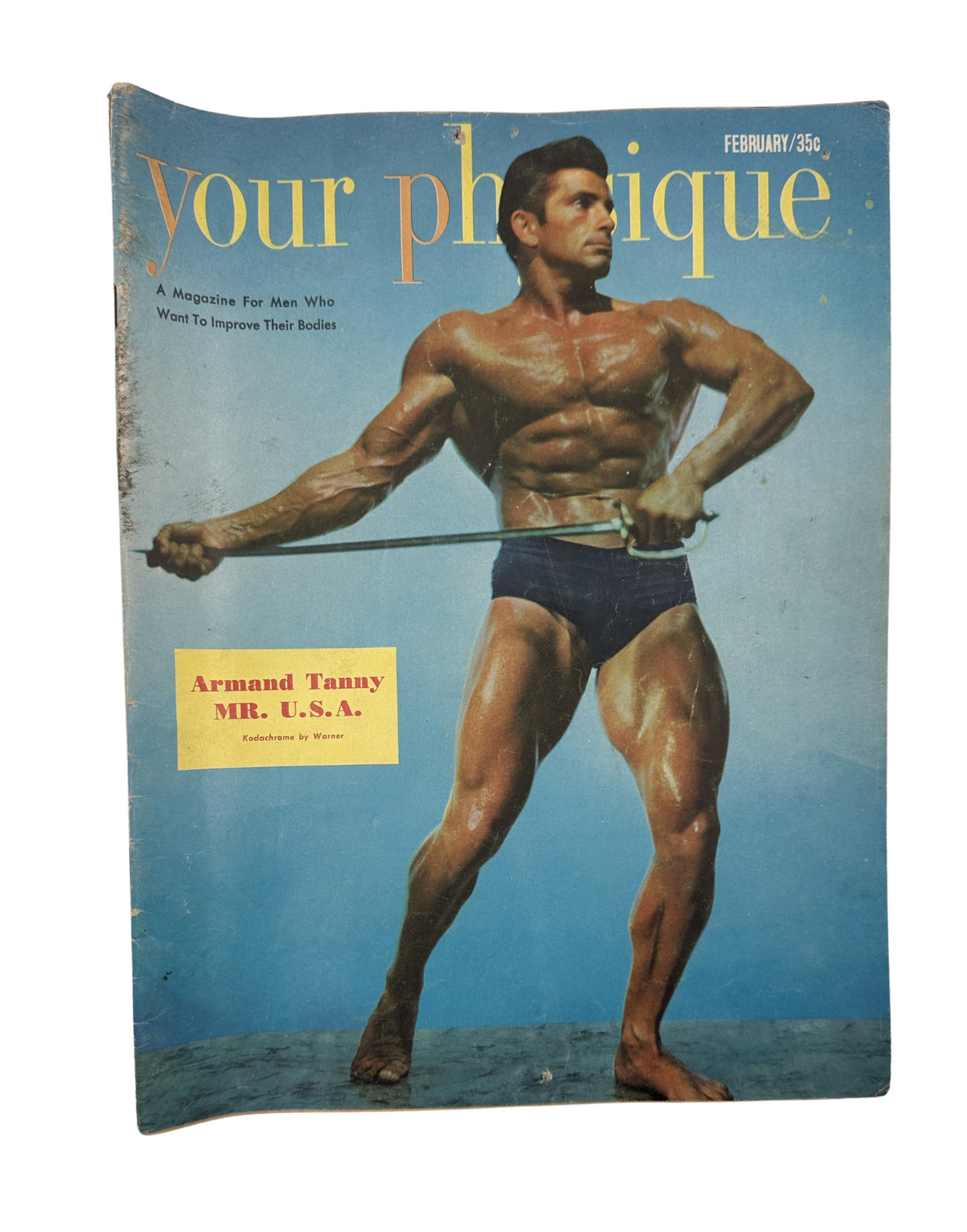 Your Physique Magazine February 1952 featuring Armand Tanny Mr. U.S.A. on the cover, showcasing a muscular figure posing with a resistance band.