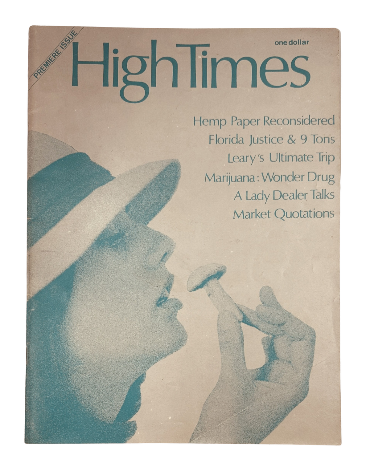 Cover of the High Times Magazine 1974 Premiere Issue featuring a woman holding a mushroom, with text highlighting articles like 'Hemp Paper Reconsidered' and 'Leary's Ultimate Trip'.