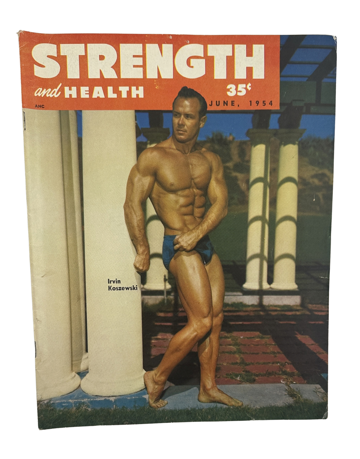 Strength and Health Magazine cover from June 1954 featuring Irvin Koszewski showcasing bodybuilding physique outdoors with classic architecture in the background.