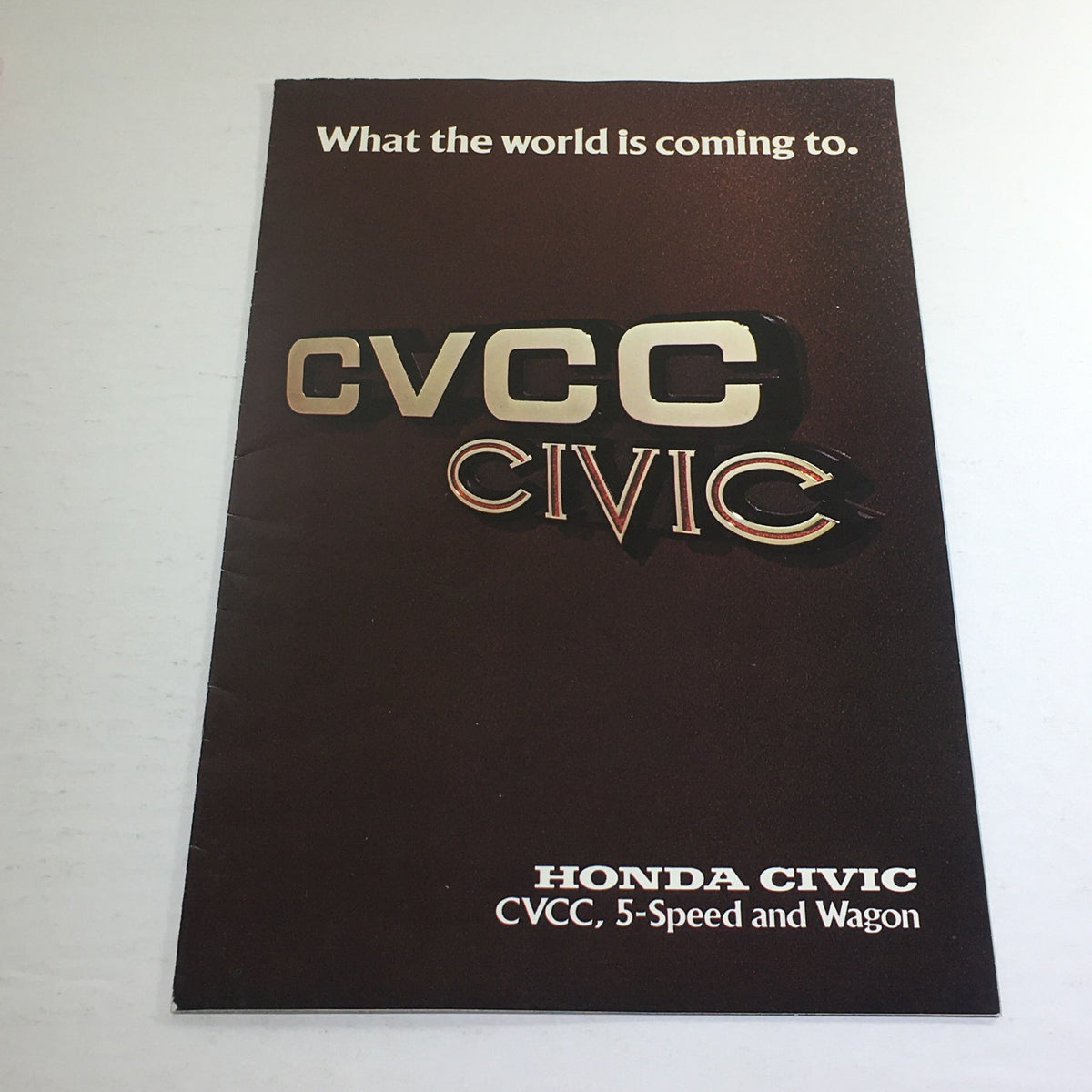 Front cover of the 1976 Honda CVCC 5-Speed Wagon Dealership Car Auto Brochure Catalog, featuring 'CVCC Civic' logo and tagline 'What the world is coming to'.