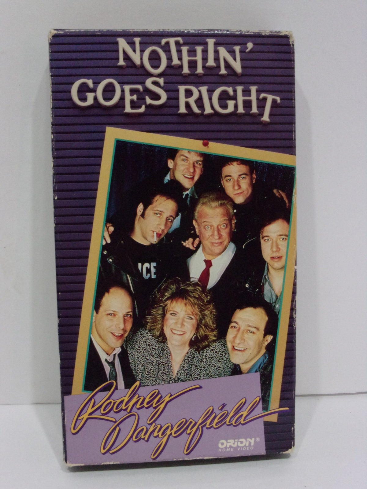 Front cover of Nothin' Goes Right Rodney Dangerfield VHS featuring a group photo of Rodney Dangerfield with cast members against a purple background.