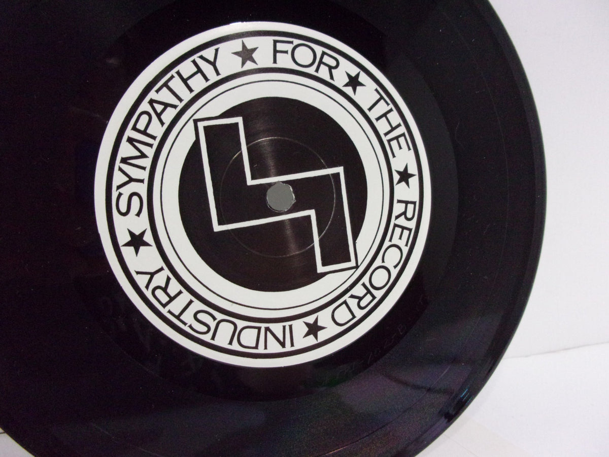 Close-up of the 'Sympathy for the Record Industry' label on the Skullflower: Evel Knievel SFTRI 202 7" Single vinyl record, highlighting its detailed design.